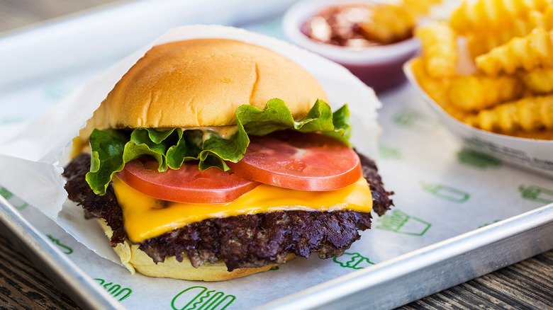 cheeseburger on tray with fries