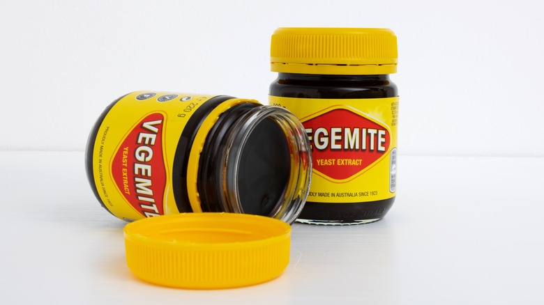 two bottles of vegemite wiht one opened