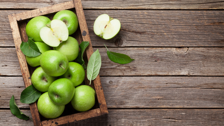 Green apples on wood surface