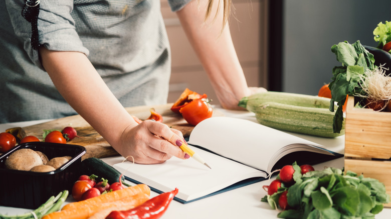 Woman uses cookbook