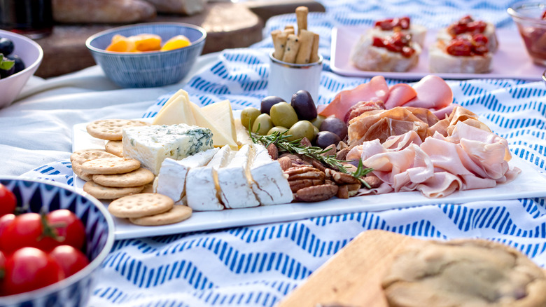 Cheese and meat on picnic blanket