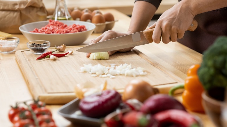 Woman chopping fresh ingredients 