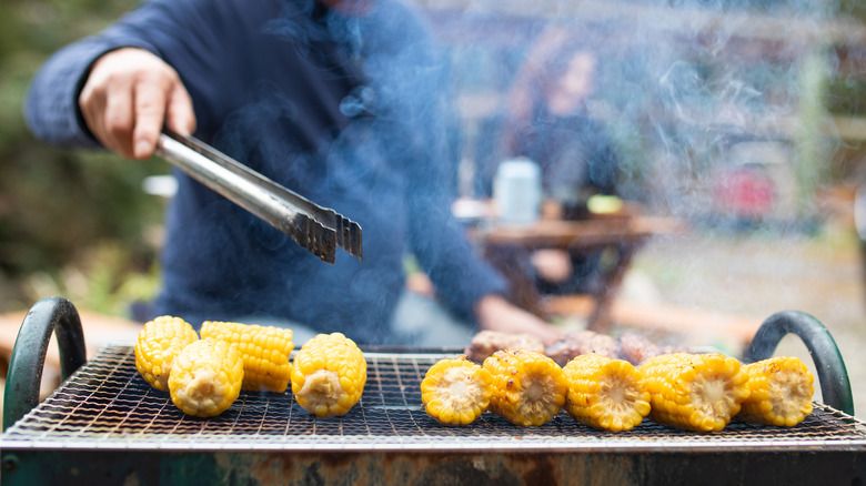 Man grilling corn on cob