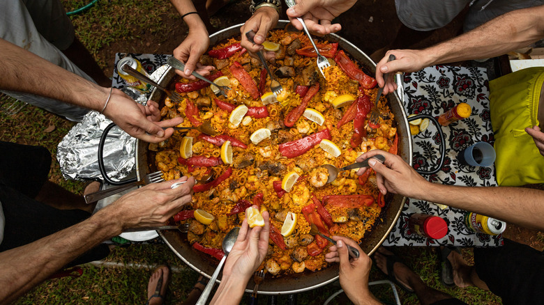 people serving paella