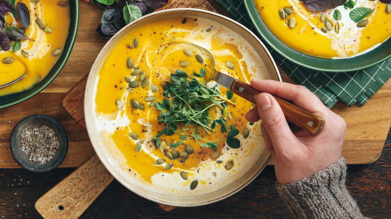 creamy pumpkin soup on table