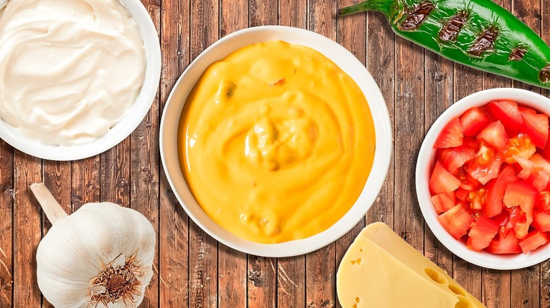 Bowl of queso with condiments