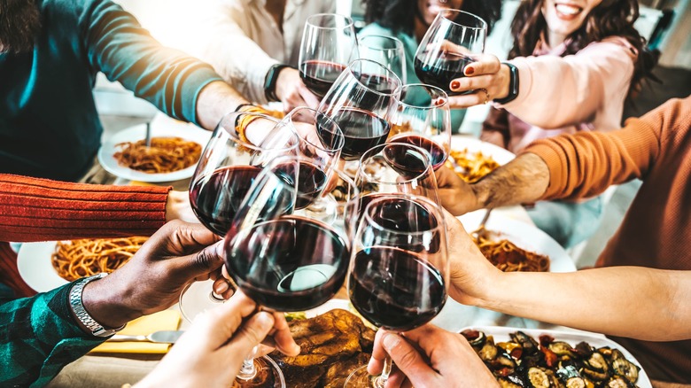 Group clinking wine glasses