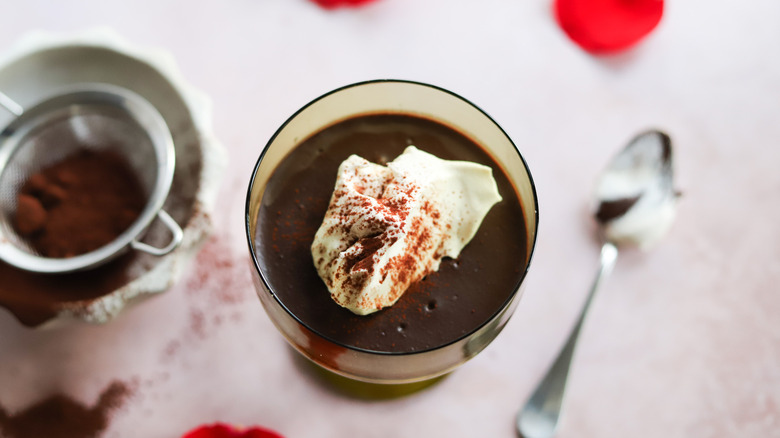 chocolate pudding with whipped cream in glass