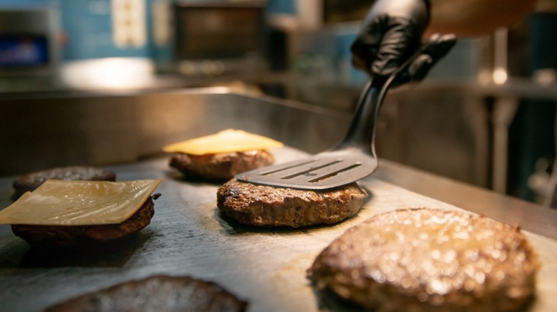 Burgers being cooked on flattop