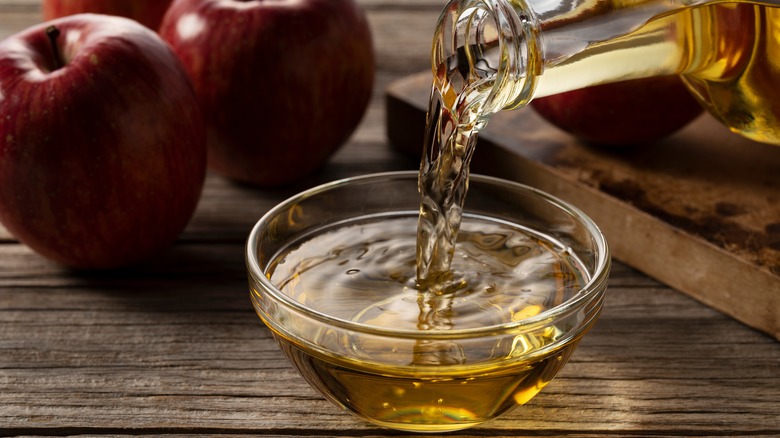 apple cider vinegar being poured