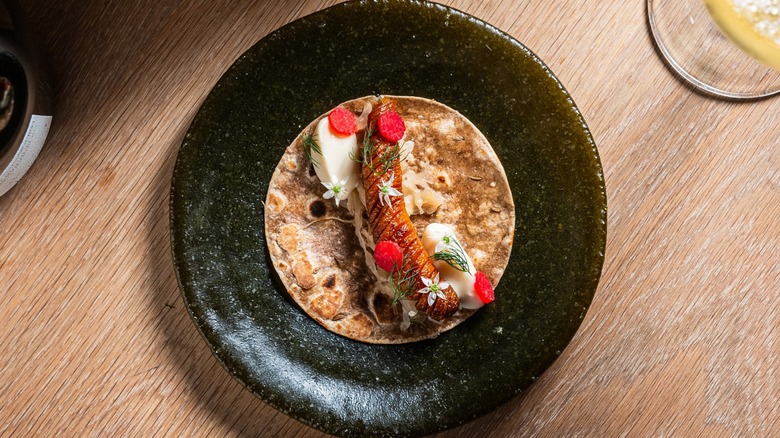 Top-down view of a wine plate and dish at Oyster Oyster