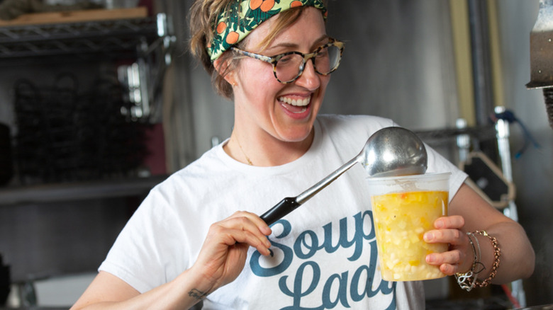 Caroline Wright ladling soup and smiling