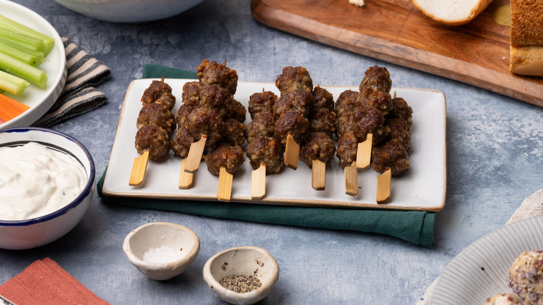 Broiled meatballs on wooden skewers