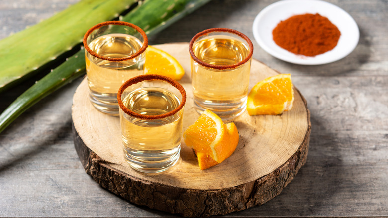 glasses of mezcal with oranges