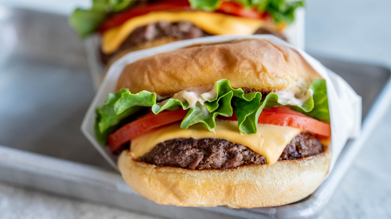 cheeseburgers on metal tray