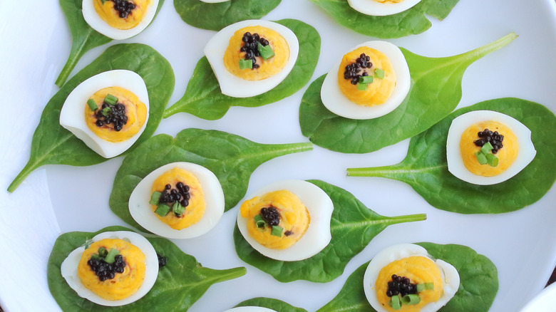 Deviled quail eggs with caviar