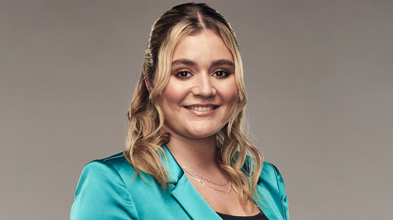 Tilly Ramsay smiling in green blazer