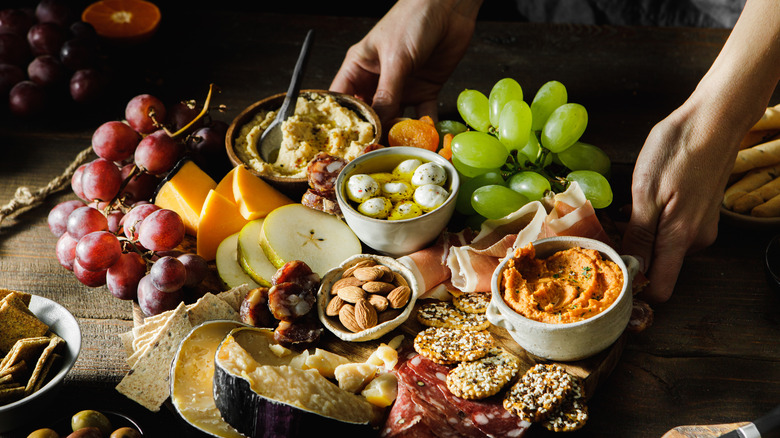 hostess serving charcuterie board