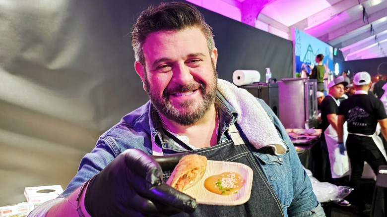 Adam Richman holding his egg roll