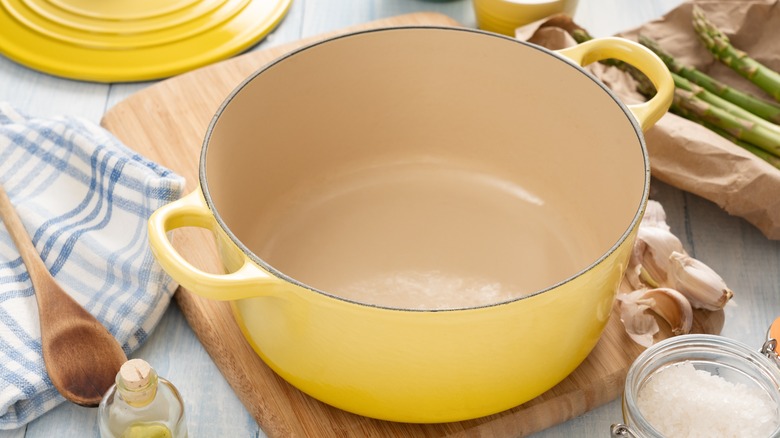 yellow Dutch oven on cutting board