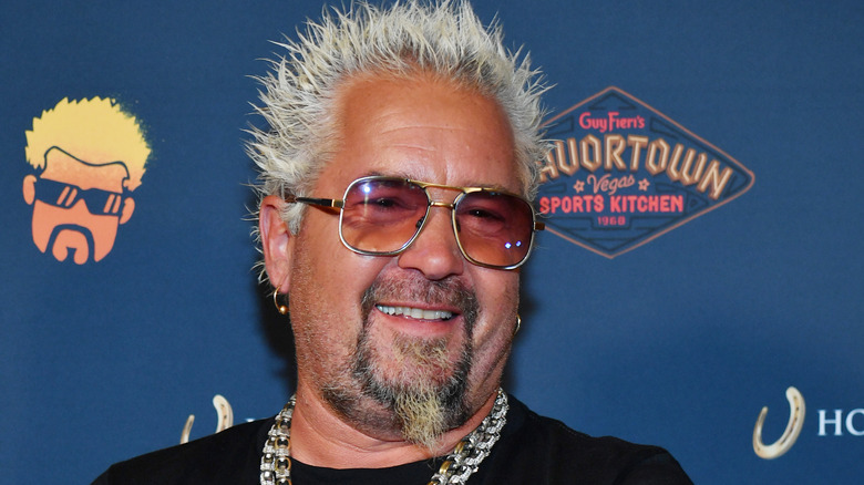 Guy Fieri smiling in sunglasses