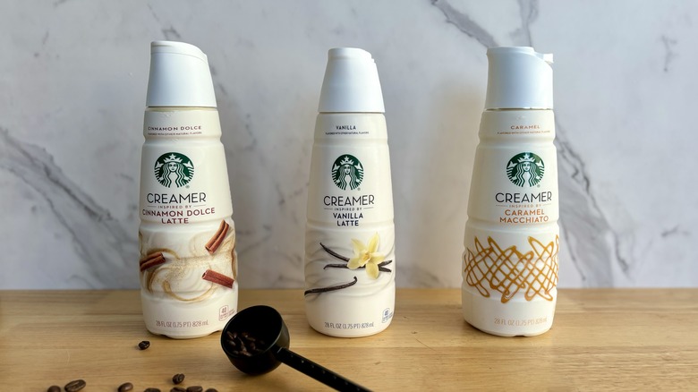 three Starbucks creamers