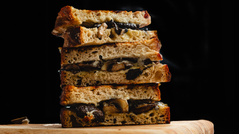 Stack of sandwich halves on cutting board