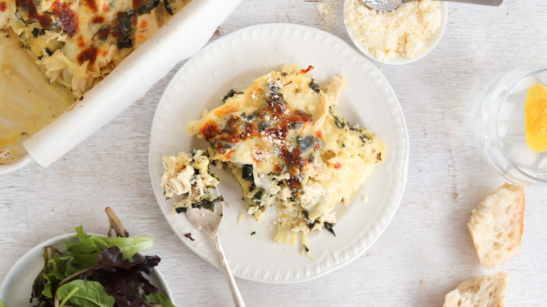 spinach and chicken lasagna sliced from baking dish