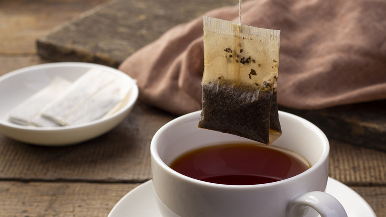 Tea bag over cup of tea