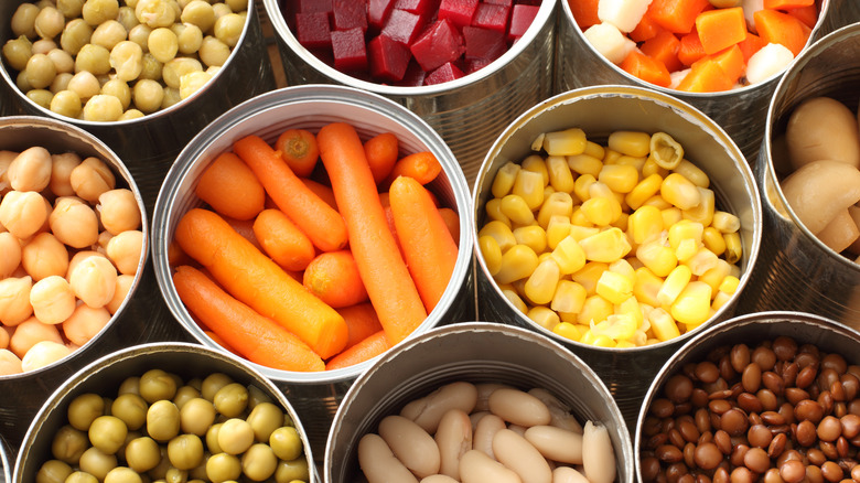 Array of open cans of beans and vegetables