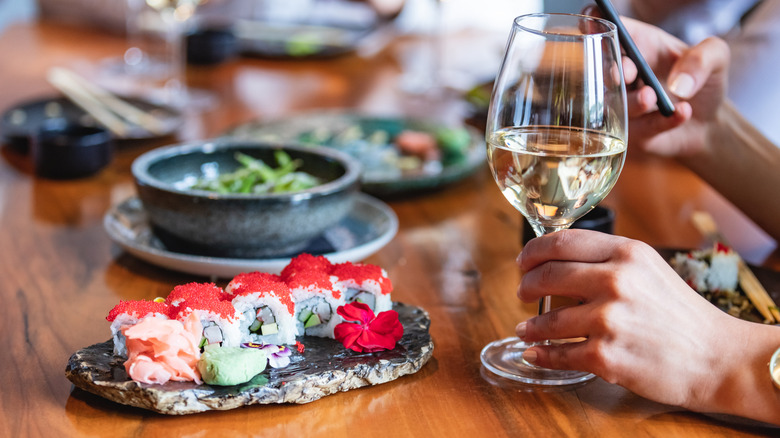 sushi plate and glass of wine