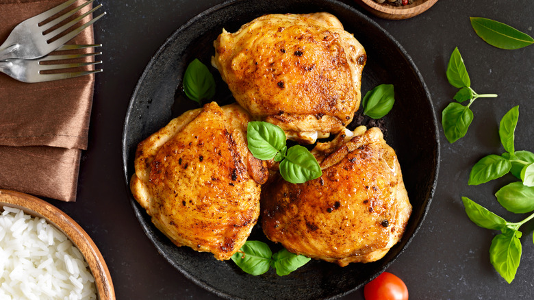 Crispy chicken thighs and fresh herbs