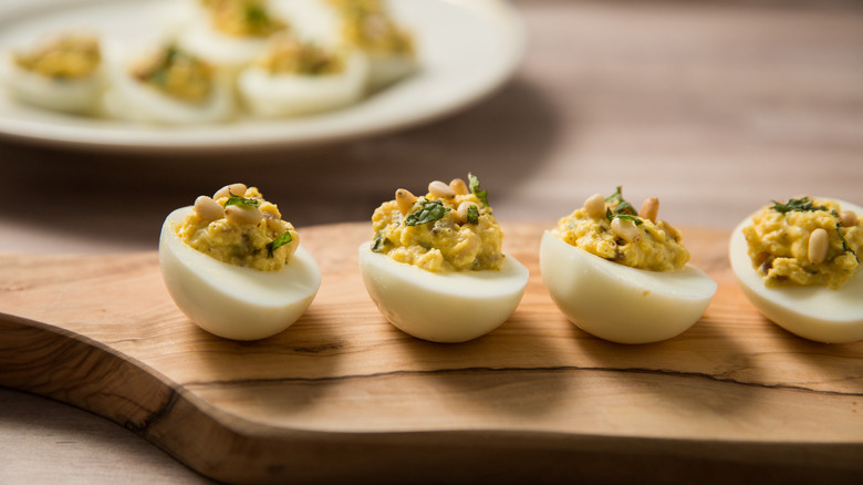 deviled eggs on wooden board 