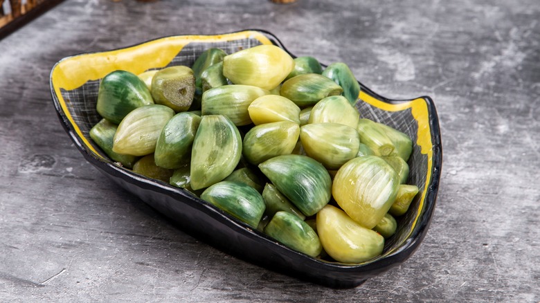 Green garlic bulbs in bowl