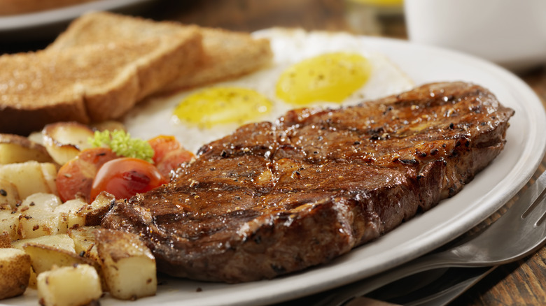 served plate of steak and eggs