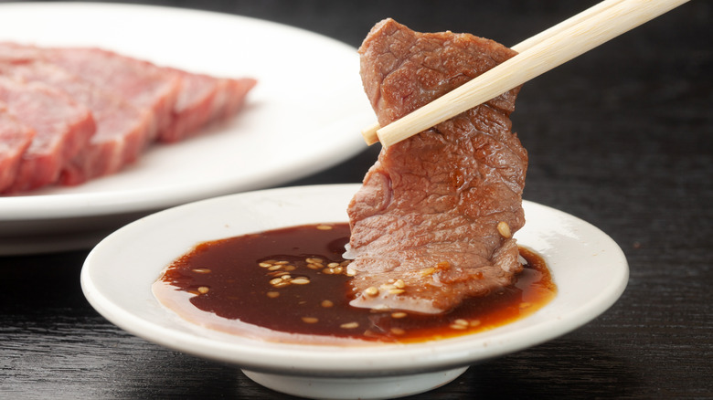 raw meat and barbecue sauce in a saucer